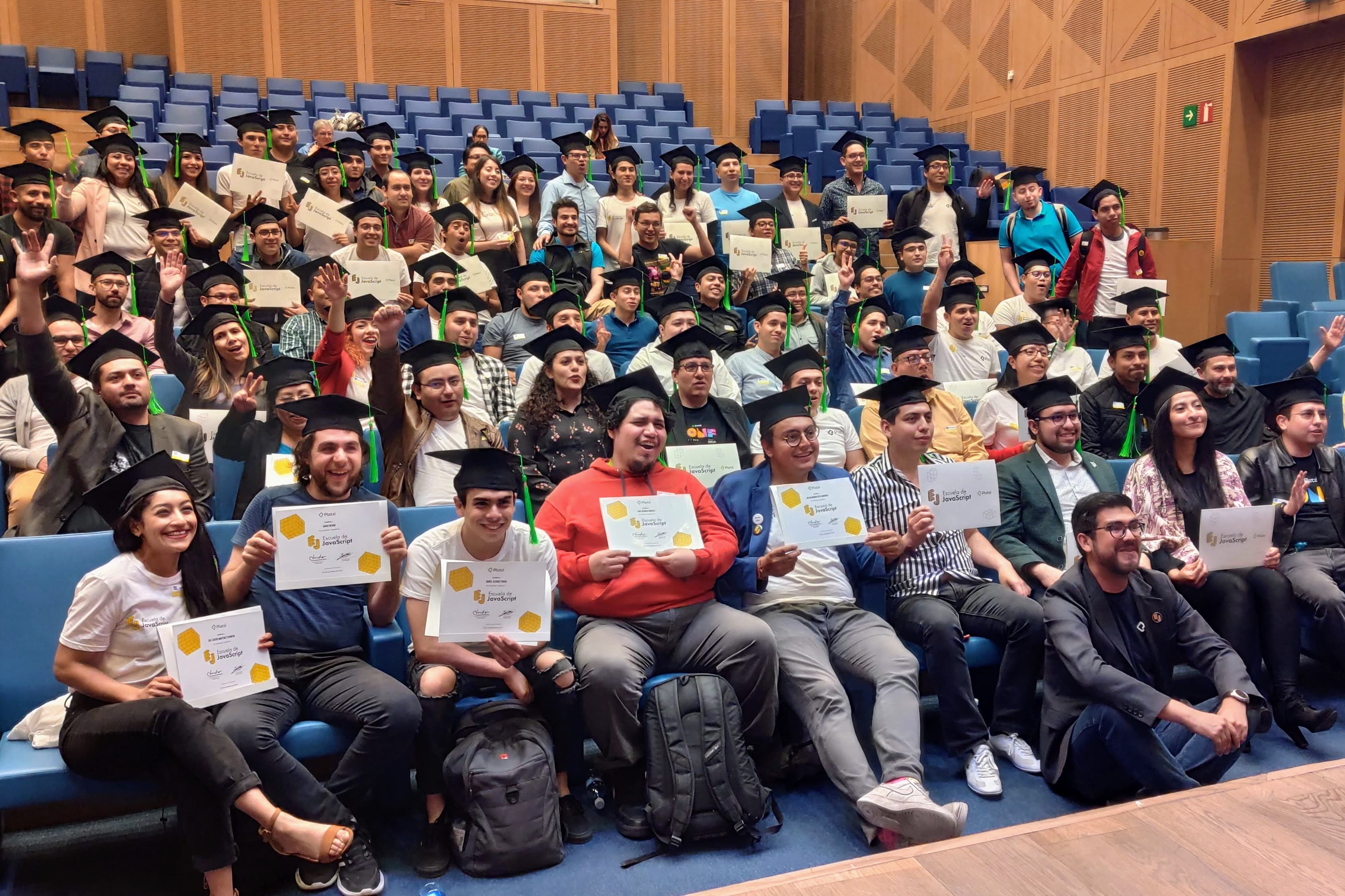 A photograph of all the graduates from the Javascript School holding their diplomas.