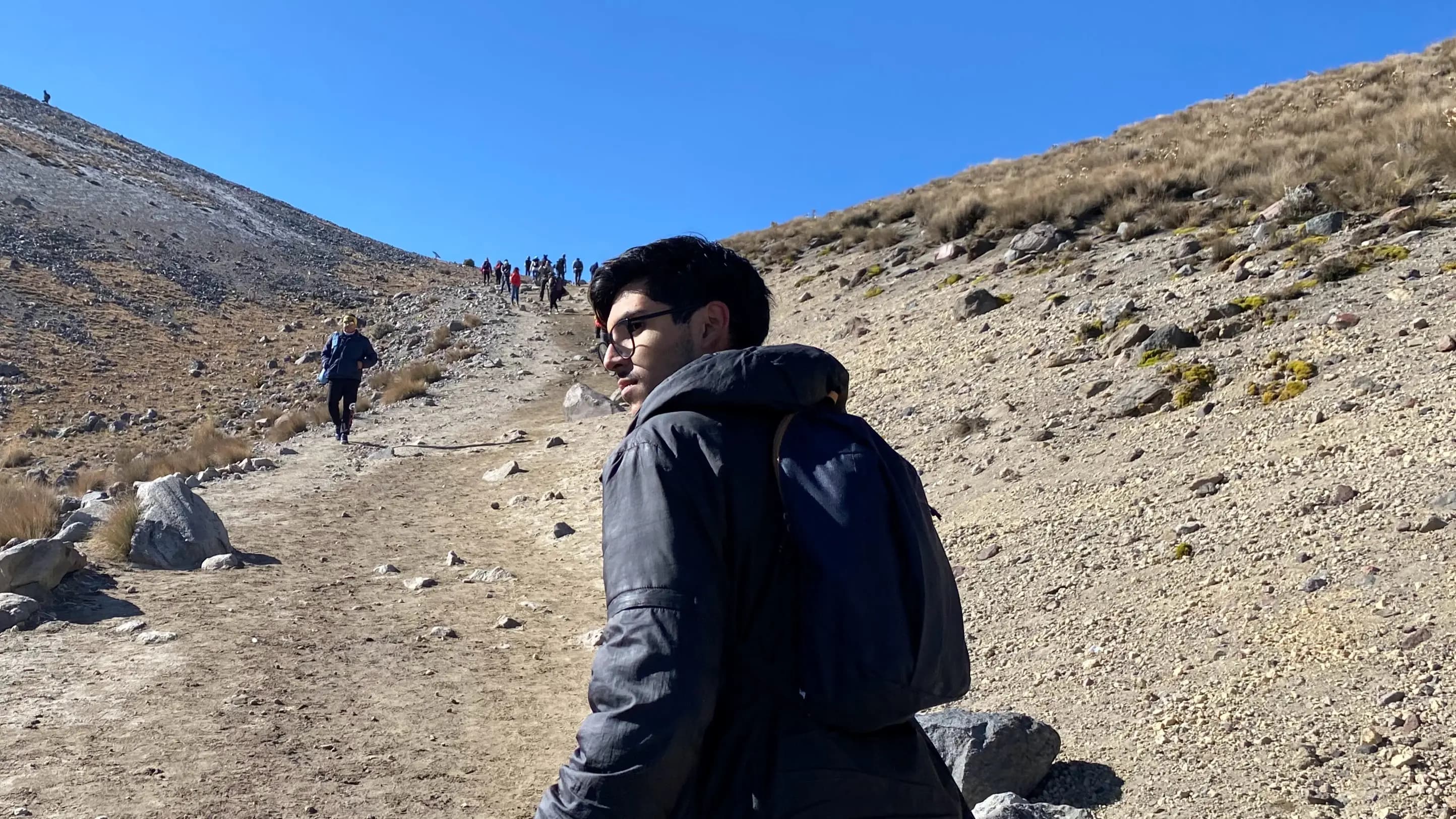 Una fotografía de mi en una montaña de espaldas medianamente volteado.